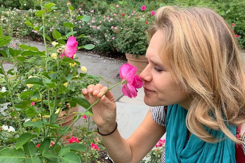 Blonde Woman Smelling Flowers
