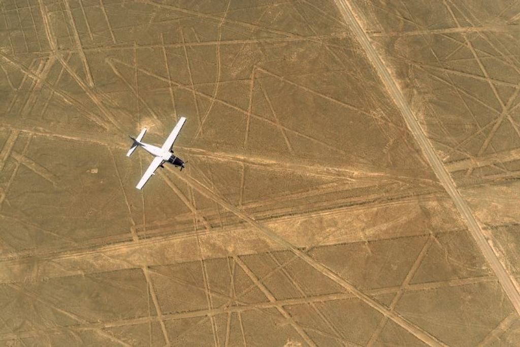 Airplane Flying Over Geoglyphs